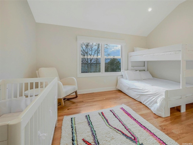 bedroom featuring wood-type flooring and vaulted ceiling