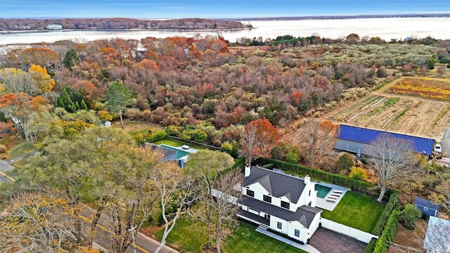 birds eye view of property with a water view