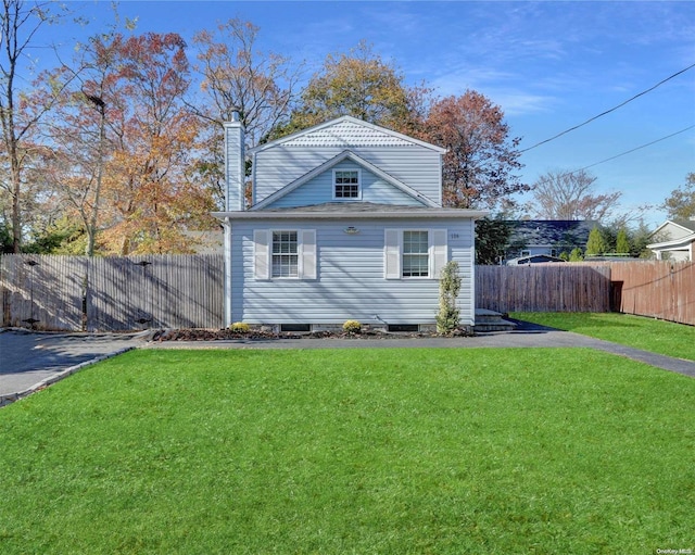 rear view of property featuring a yard