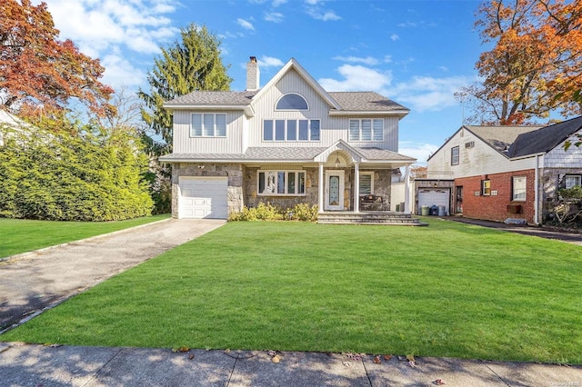 view of front facade with a front yard and a garage