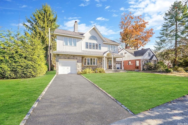 view of front of property featuring a garage and a front yard