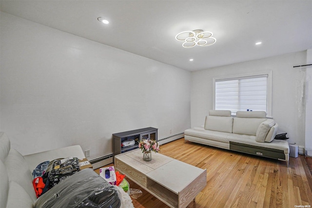 living room featuring baseboard heating and wood-type flooring