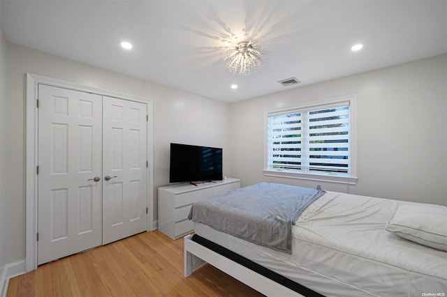 bedroom featuring light hardwood / wood-style floors and a closet