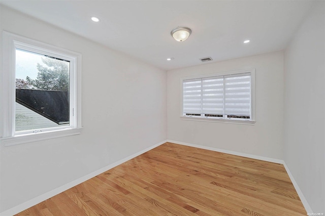 unfurnished room with light hardwood / wood-style floors