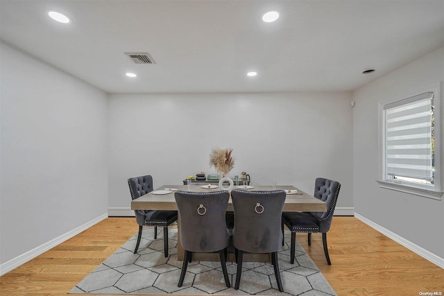 dining space featuring light wood-type flooring