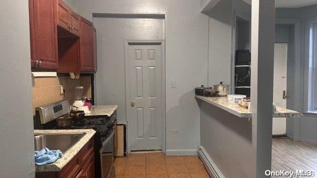 kitchen featuring electric range and tasteful backsplash