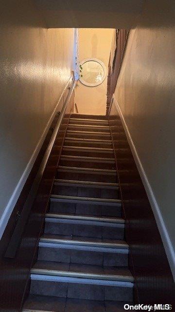 staircase with tile patterned flooring