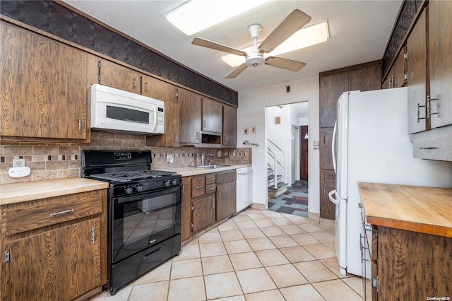 kitchen featuring decorative backsplash, white appliances, ceiling fan, and sink