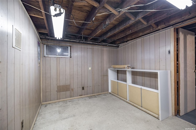 basement with wood walls and carpet