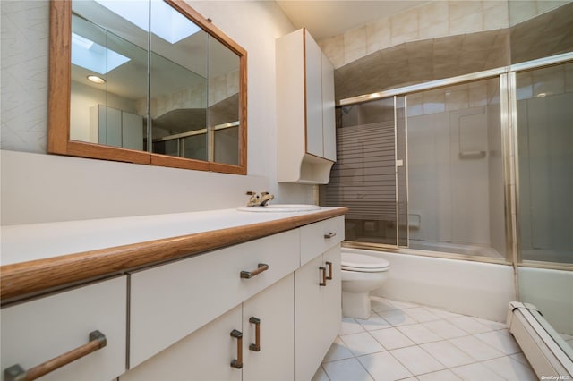 full bathroom featuring combined bath / shower with glass door, a skylight, tile patterned floors, vanity, and a baseboard heating unit