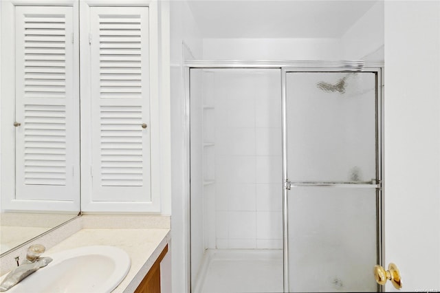 bathroom featuring an enclosed shower and vanity