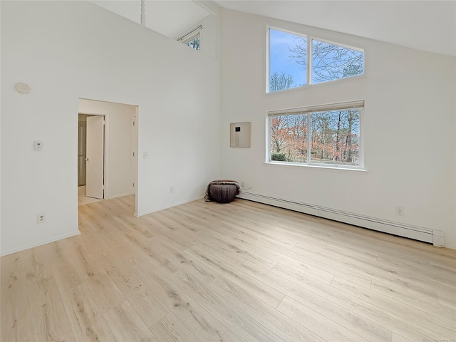 unfurnished living room featuring light hardwood / wood-style flooring, high vaulted ceiling, and a baseboard heating unit