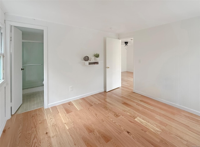 unfurnished room with ceiling fan and light hardwood / wood-style floors