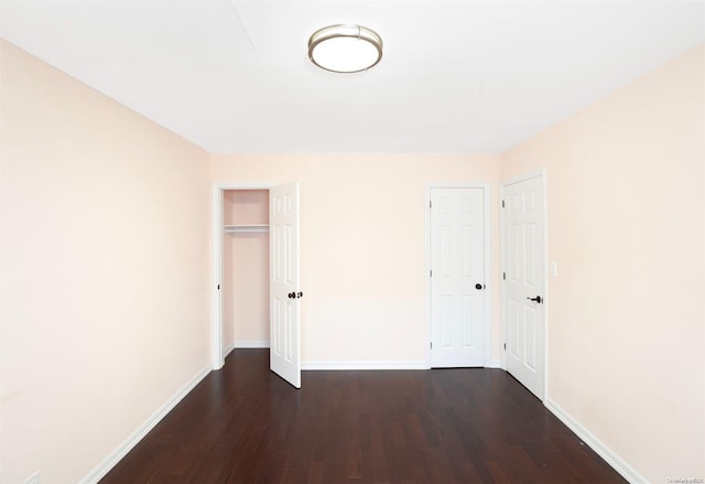 unfurnished bedroom featuring dark hardwood / wood-style flooring