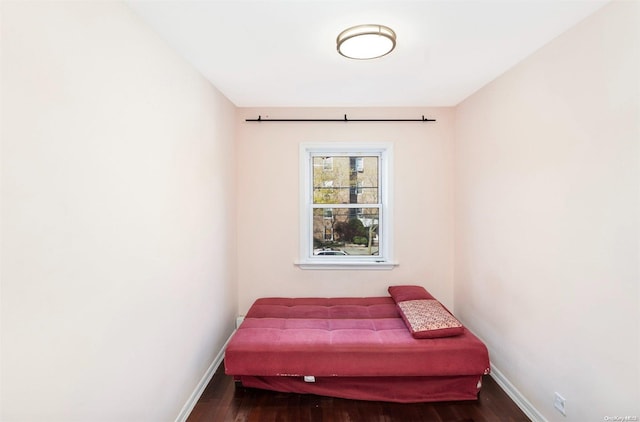 bedroom with dark wood-type flooring