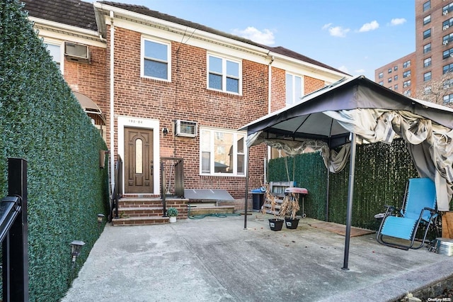 exterior space with a gazebo and a wall unit AC