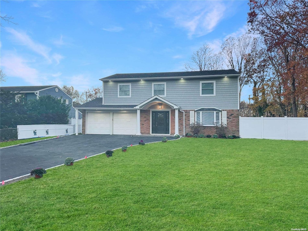 view of front of house with a garage and a front yard