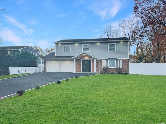 view of front of house with a garage and a front yard