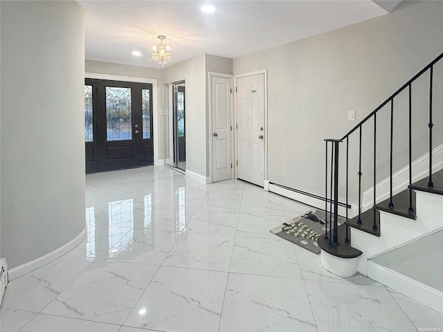 foyer entrance featuring a baseboard heating unit and an inviting chandelier