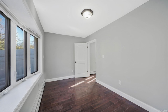 spare room featuring dark wood-type flooring