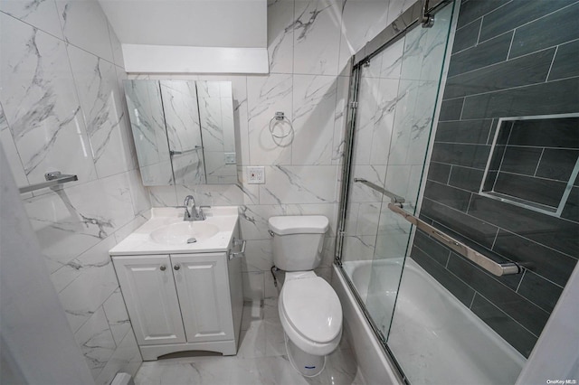 full bathroom featuring vanity, toilet, enclosed tub / shower combo, and tile walls