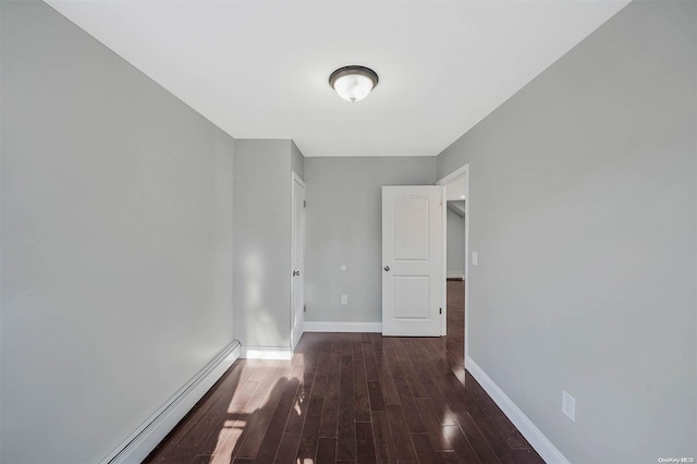 hallway with dark hardwood / wood-style flooring and a baseboard heating unit