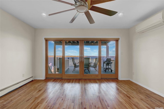 unfurnished room featuring a wall unit AC, ceiling fan, light hardwood / wood-style flooring, and a healthy amount of sunlight