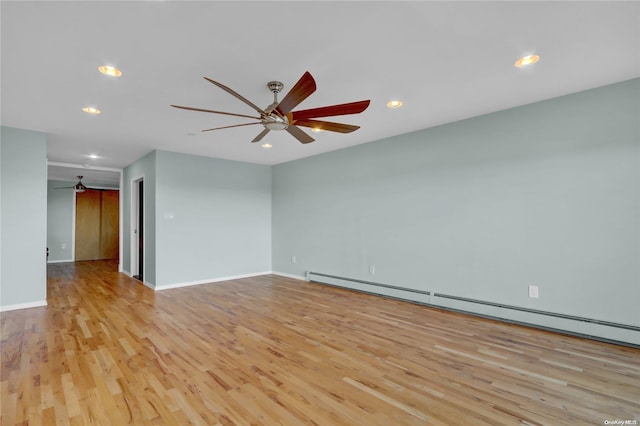 spare room featuring light hardwood / wood-style flooring and a baseboard radiator