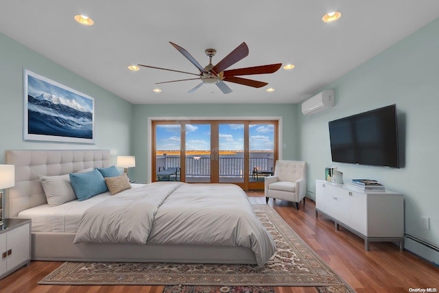 bedroom with access to exterior, ceiling fan, baseboard heating, an AC wall unit, and hardwood / wood-style flooring