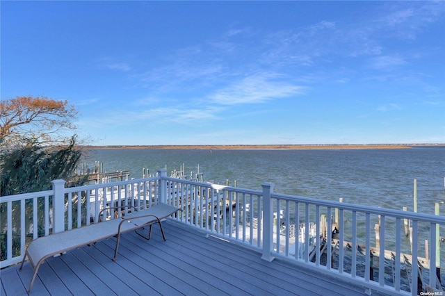 deck with a dock and a water view