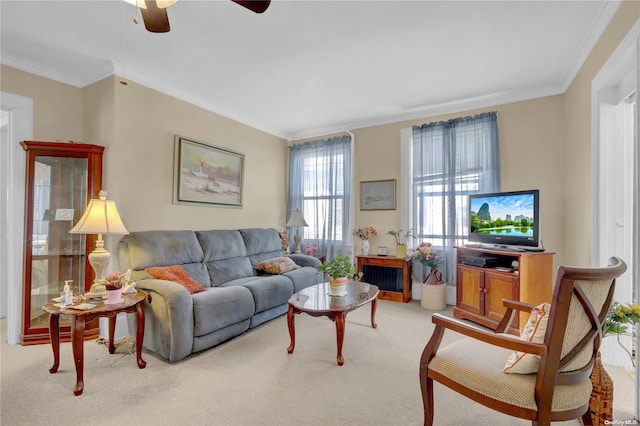 carpeted living room with ceiling fan and ornamental molding