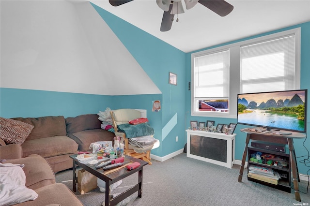 carpeted living room with ceiling fan and lofted ceiling