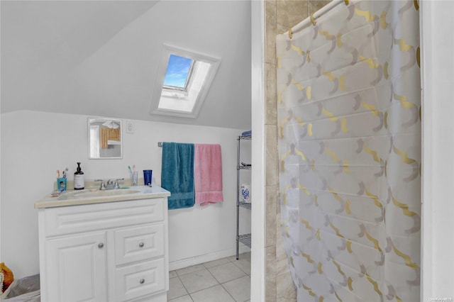 bathroom featuring walk in shower, vaulted ceiling with skylight, vanity, and tile patterned flooring