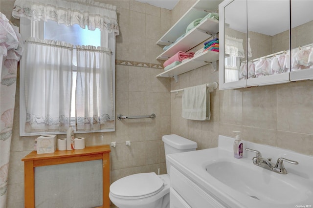 bathroom featuring a wealth of natural light, tile walls, and toilet