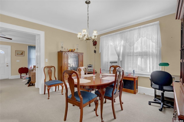 dining area featuring light carpet, ceiling fan with notable chandelier, and crown molding