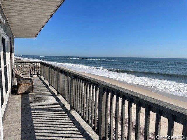 balcony with a beach view and a water view