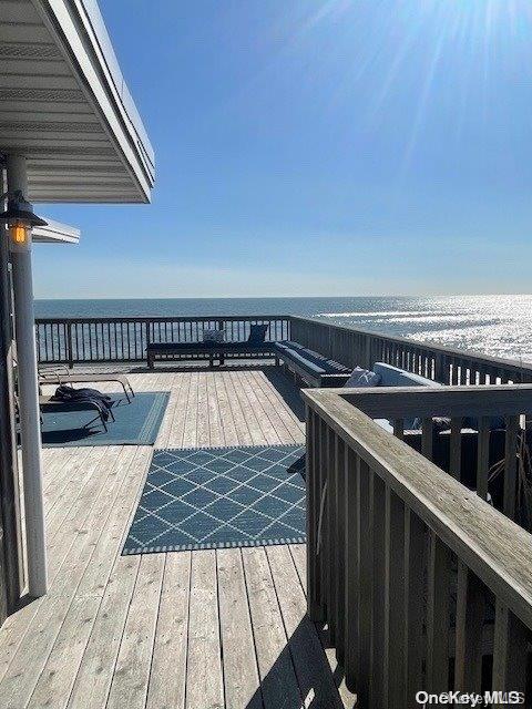 deck featuring a water view and a view of the beach