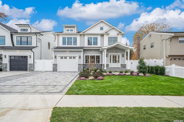 view of front of home featuring a garage and a front lawn