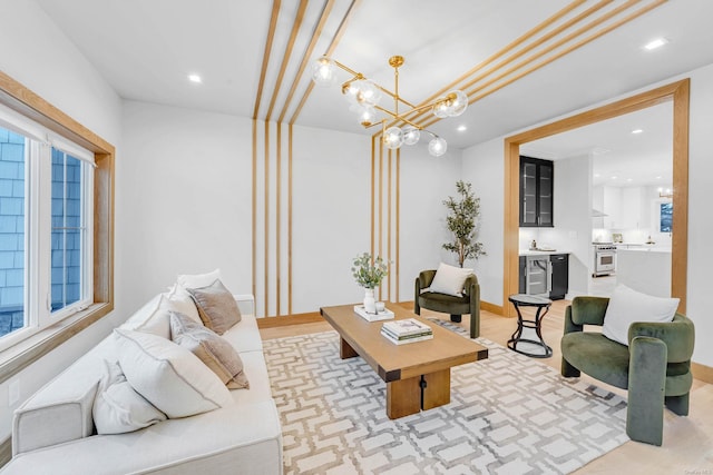 living room with wine cooler and a notable chandelier