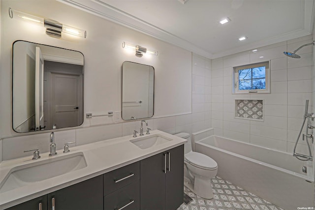 full bathroom with ornamental molding, vanity, tiled shower / bath combo, tile walls, and toilet