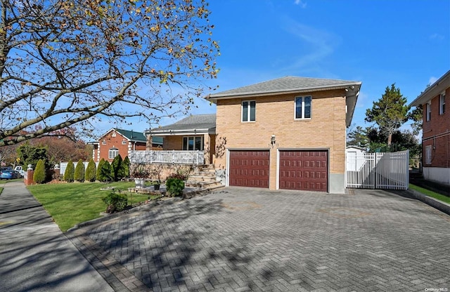 view of front of house featuring a garage and a front lawn