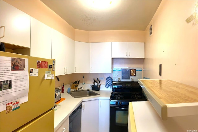 kitchen with black appliances, butcher block counters, white cabinetry, and sink