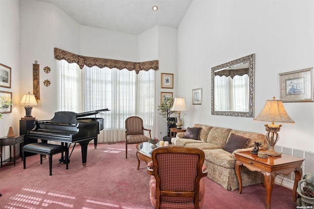 sitting room featuring carpet flooring and high vaulted ceiling