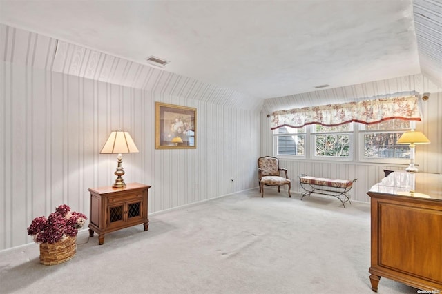 sitting room with light carpet and vaulted ceiling