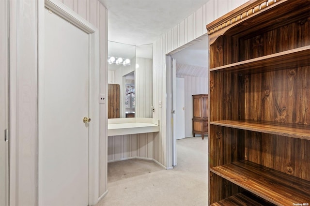 walk in closet featuring light carpet