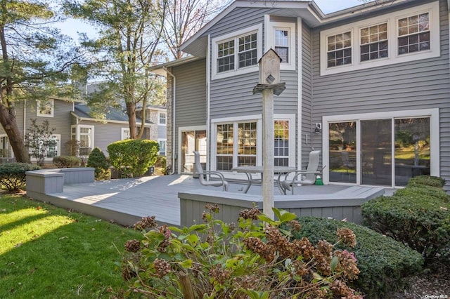 back of property featuring a wooden deck