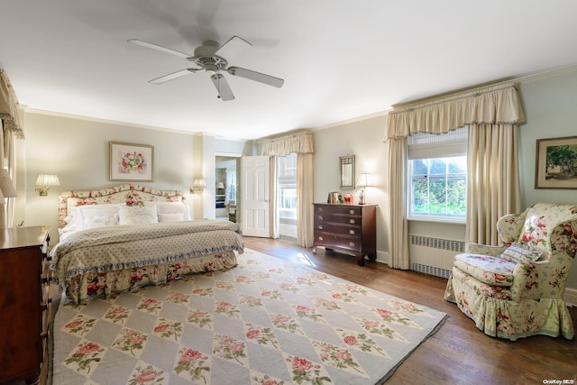 bedroom with ceiling fan, wood-type flooring, radiator heating unit, and ornamental molding