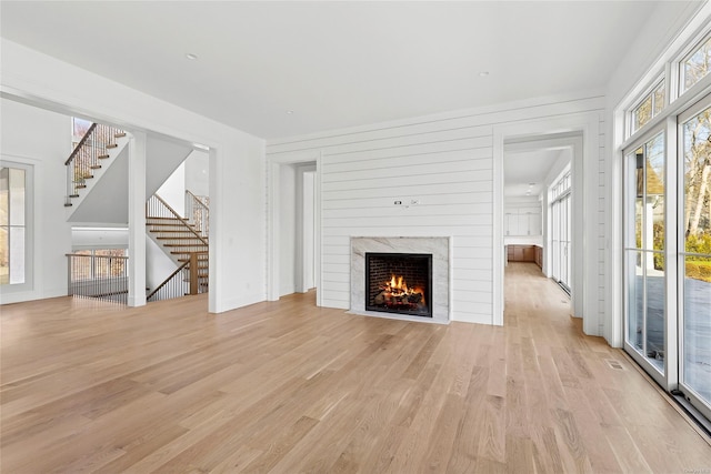 unfurnished living room with a fireplace and light hardwood / wood-style flooring