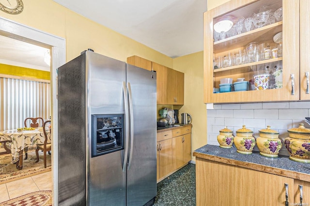 kitchen with stainless steel fridge with ice dispenser, backsplash, and ornamental molding