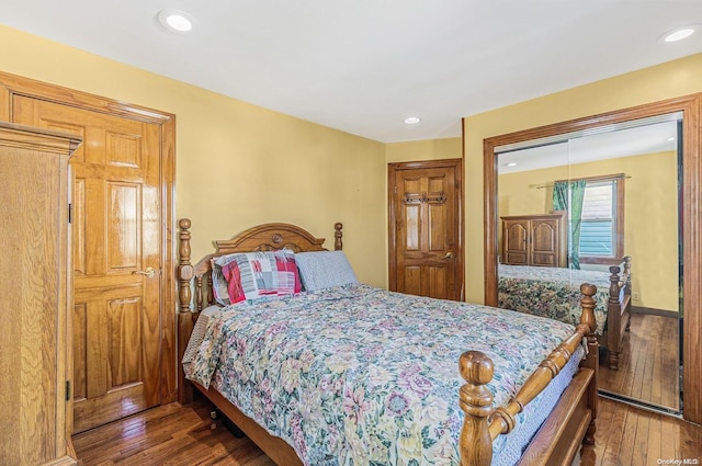 bedroom with dark wood-type flooring